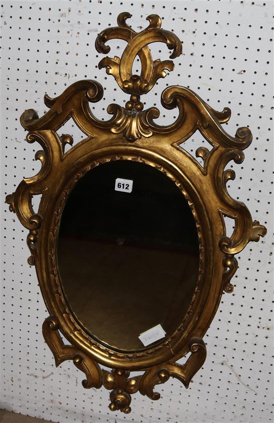 An oval Rococo gilt framed wall mirror